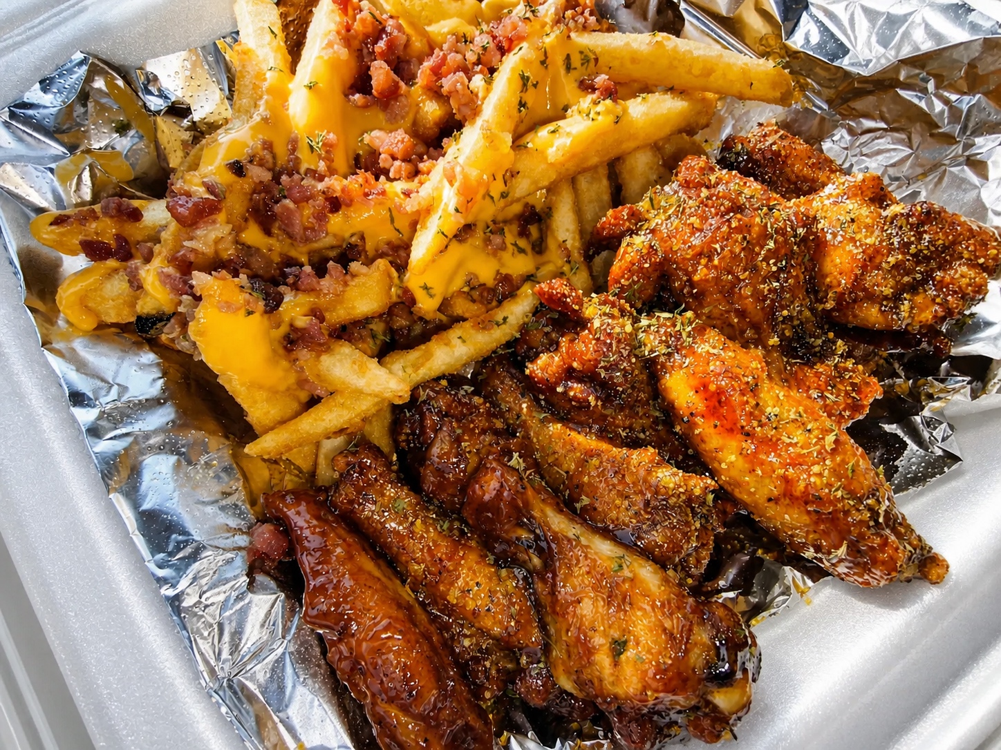 Assorted sauced wings with bacon cheese loaded fries